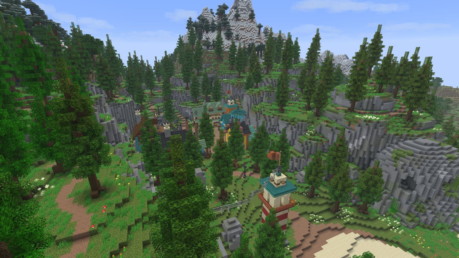 The village seen from above, among pines and mountains, with the lighthouse below